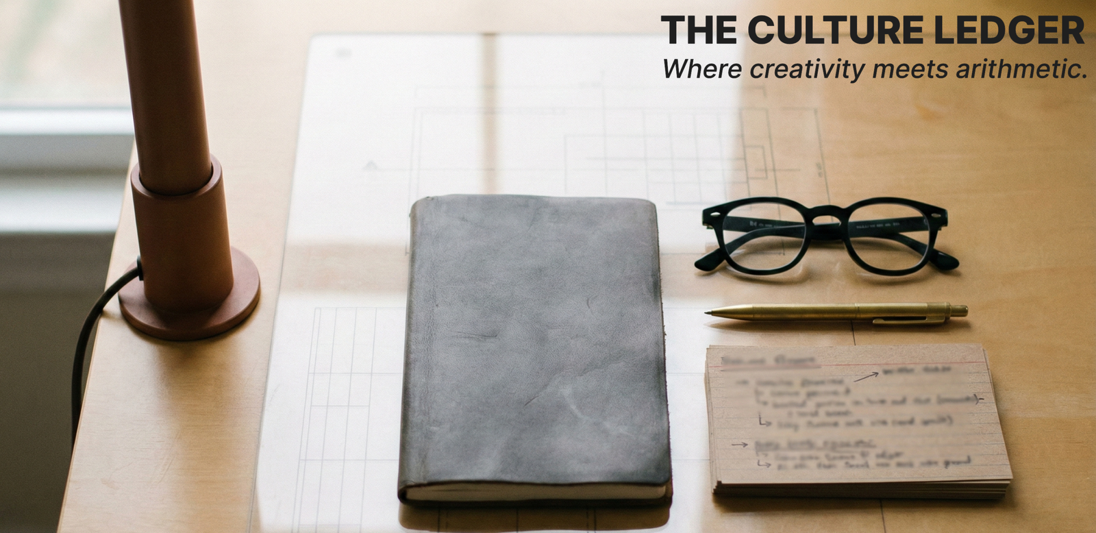 Minimalist ultra-wide Culture Ledger banner featuring a warm-sand tabletop, a clay-brown vertical beam on the left, and neatly arranged creative-strategy tools.