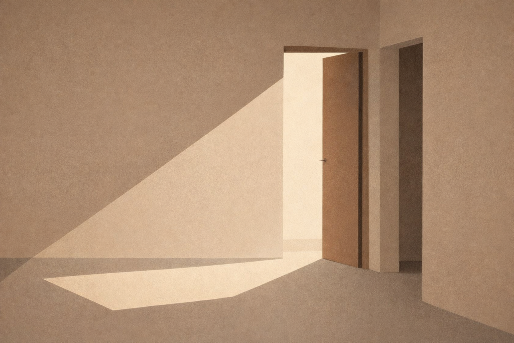 A quiet interior space with a partially open doorway and light entering from one side, representing choice made within constraint rather than unlimited options.