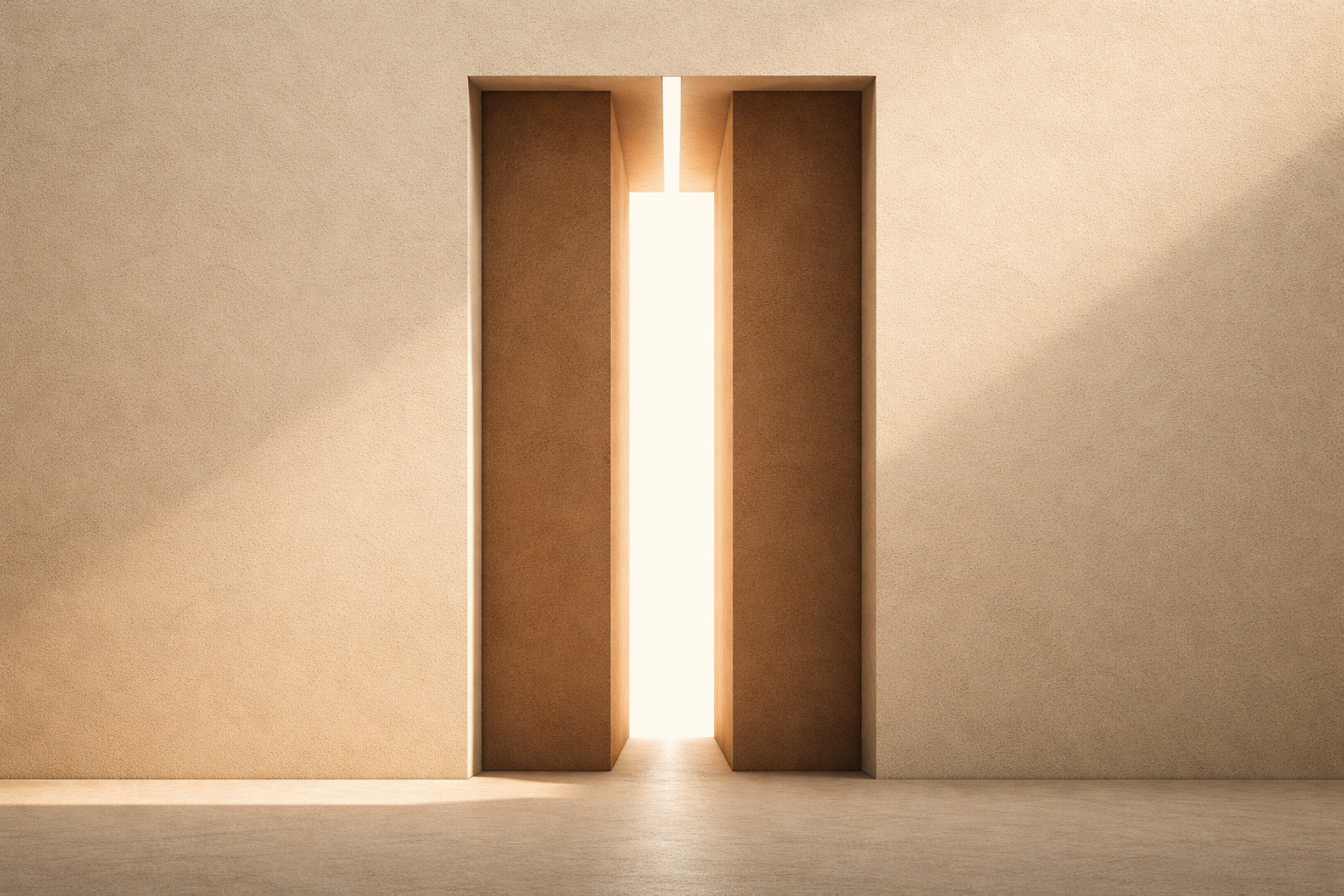 Two clay-brown columns separated by illuminated vertical gap of light