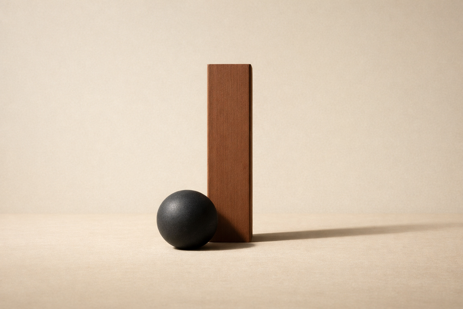 Minimalist still life of a clay beam and charcoal sphere symbolizing emotional discipline and controlled reaction.