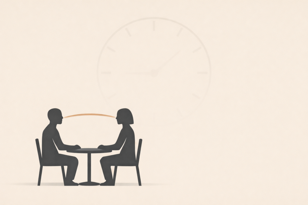 Minimalist illustration of two silhouettes at a table symbolizing first date first impressions forming quickly.
