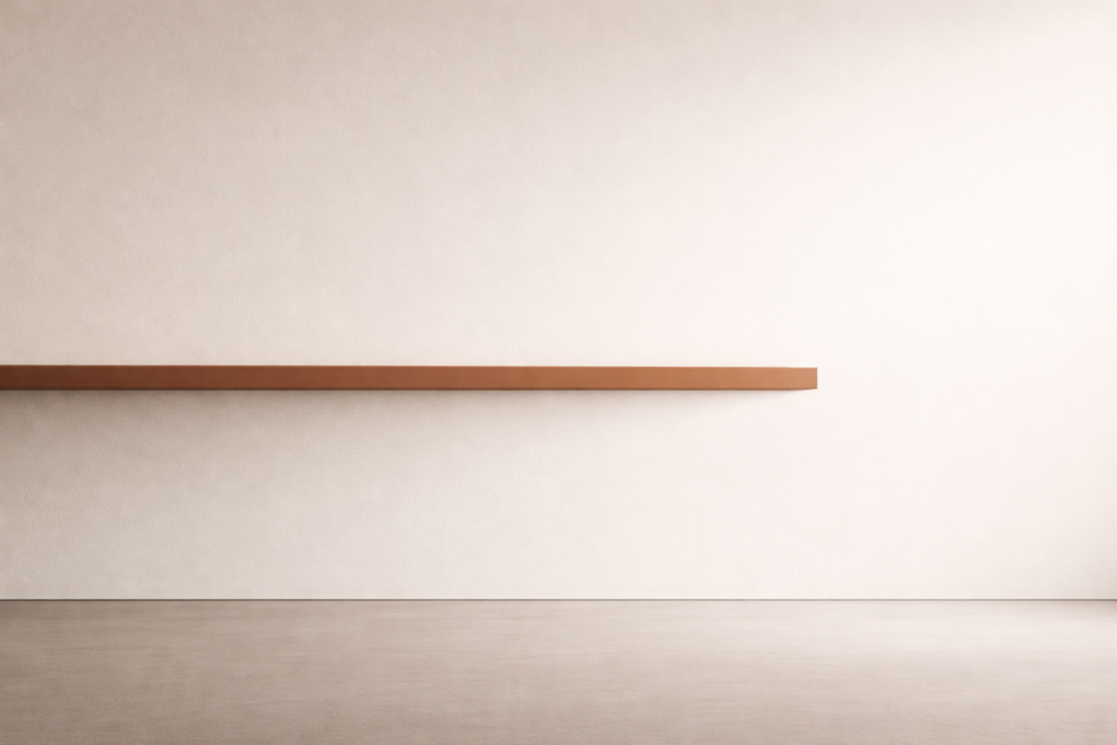 Minimalist architectural interior rendered in warm sand with a clay-brown horizontal beam embedded into the wall and a faint charcoal shadow above, symbolizing interior structure and disciplined introspection.