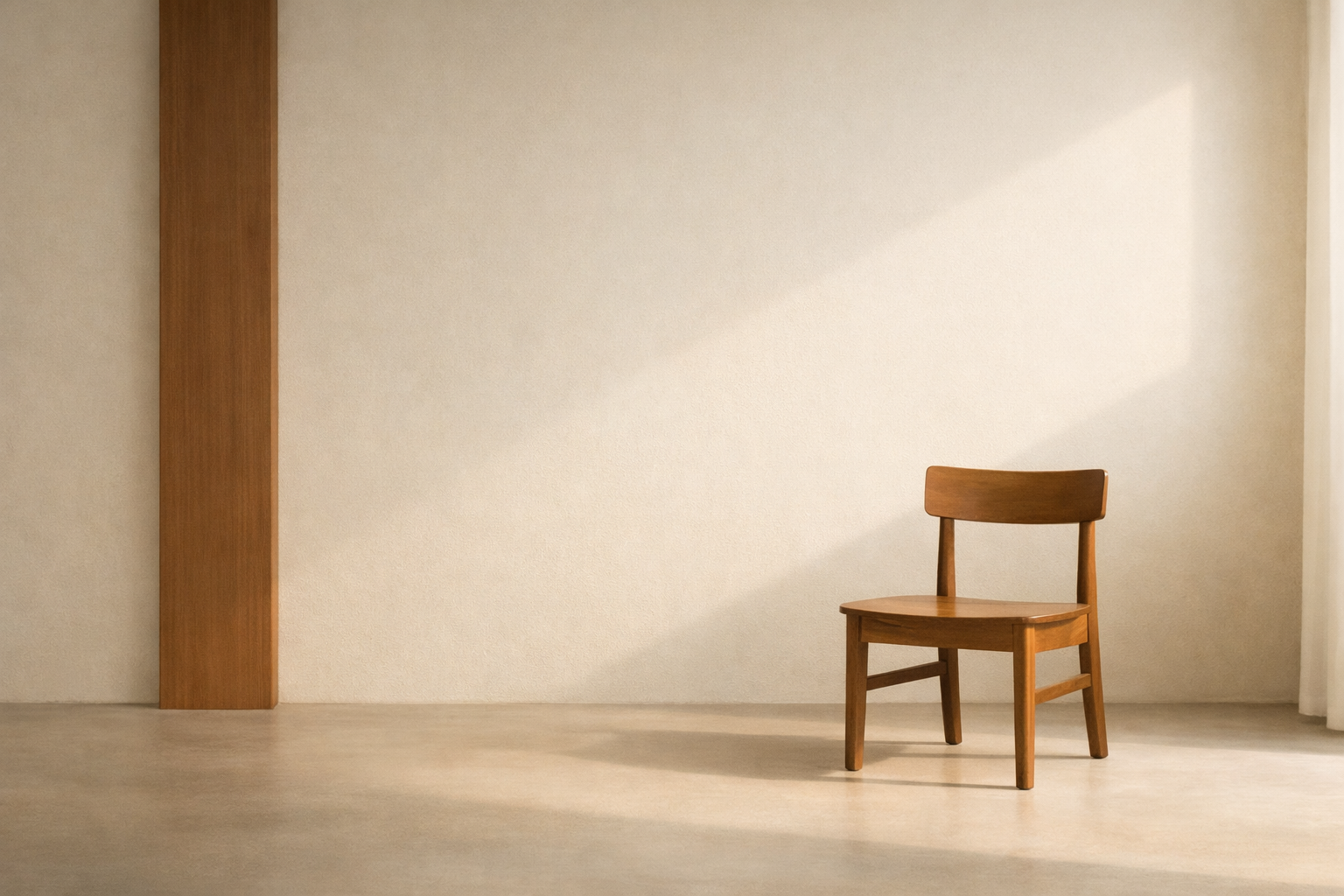 Emotional restraint is strength illustrated through minimalist interior with clay-brown structural beam and wooden chair in stillness.